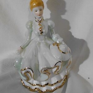 Elegant Porcelain Figurine with Gold Accents